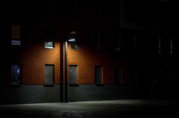 A streetlamp in a dark alley.